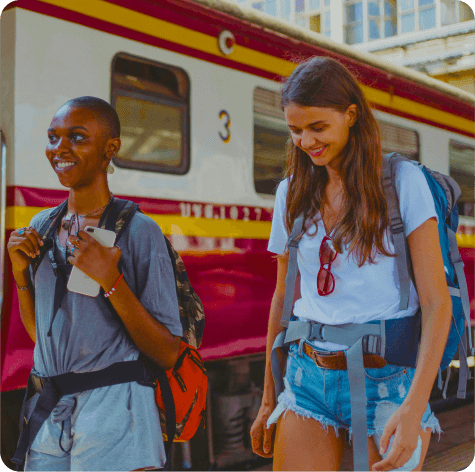 Two travelers standing by a train